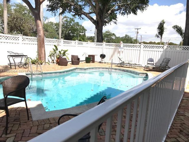 3356 Bird Avenue, Unit 10 Miami, FL 33133 - Photo 22 of 25 a view of swimming pool with a lounge chair