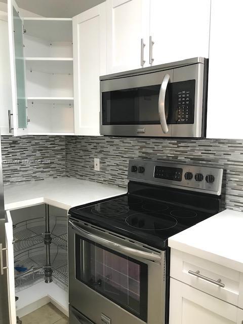 3356 Bird Avenue, Unit 10 Miami, FL 33133 - Photo 9 of 25 a stove top oven sitting inside of a kitchen