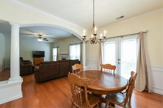 a view of a dining room with furniture window and wooden floor