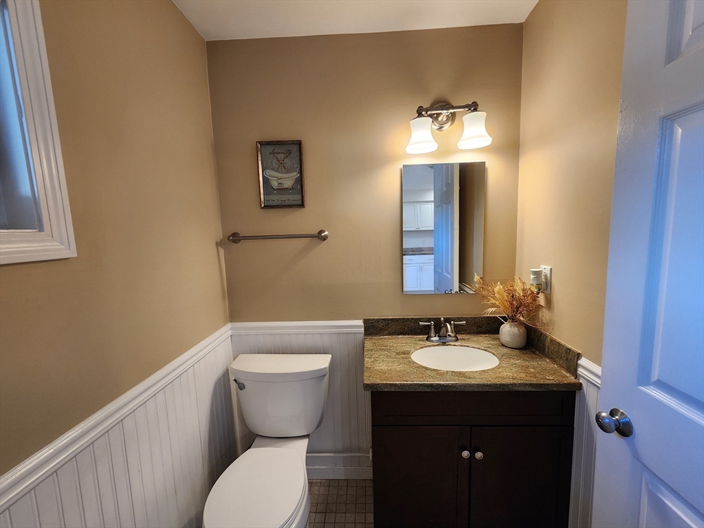 17 Beal's Cove Road, Unit A Hingham, MA 02043 - Photo 11 of 31 a bathroom with a toilet sink and mirror