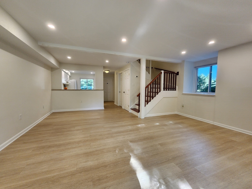 17 Beal's Cove Road, Unit A Hingham, MA 02043 - Photo 2 of 31 an empty room with wooden floor and windows
