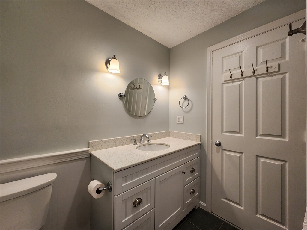 17 Beal's Cove Road, Unit A Hingham, MA 02043 - Photo 21 of 31 a bathroom with a sink double vanity and a mirror