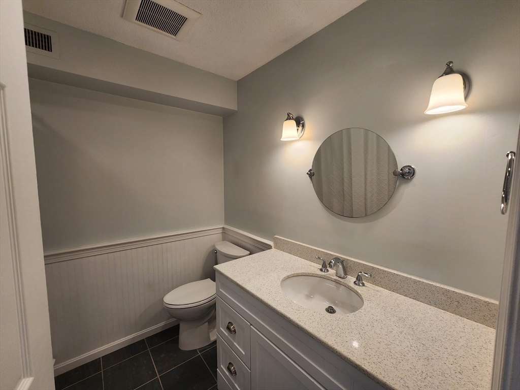 17 Beal's Cove Road, Unit A Hingham, MA 02043 - Photo 22 of 31 a bathroom with a sink a toilet and a mirror