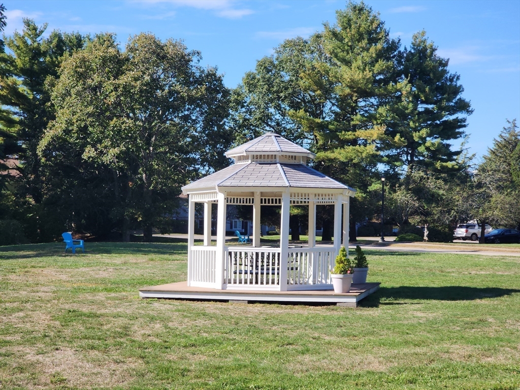 17 Beal's Cove Road, Unit A Hingham, MA 02043 - Photo 29 of 31 a view of a house with a big yard and potted plants and large trees