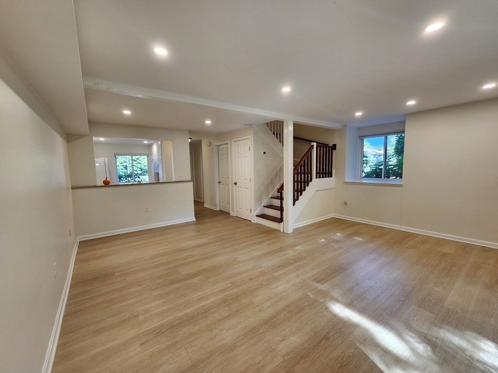 17 Beal's Cove Road, Unit A Hingham, MA 02043 - Photo 5 of 31 an empty room with wooden floor and windows