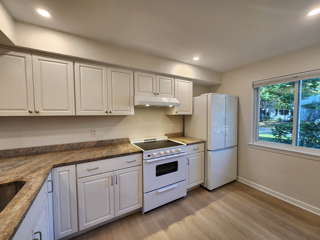 17 Beal's Cove Road, Unit A Hingham, MA 02043 - Photo 8 of 31 a kitchen with a stove a sink and a refrigerator