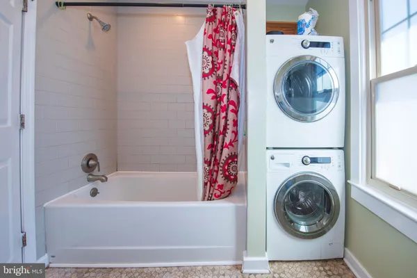 a bathroom with a bathtub and dryer