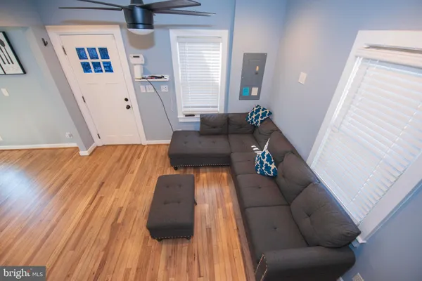 a living room with furniture and wooden floor
