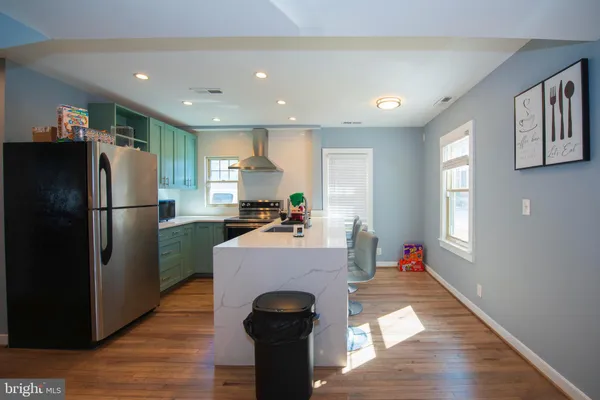 a kitchen with refrigerator and windows