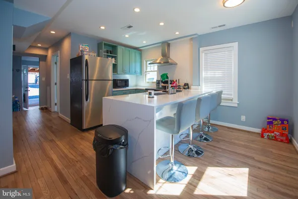 a kitchen with refrigerator and sink