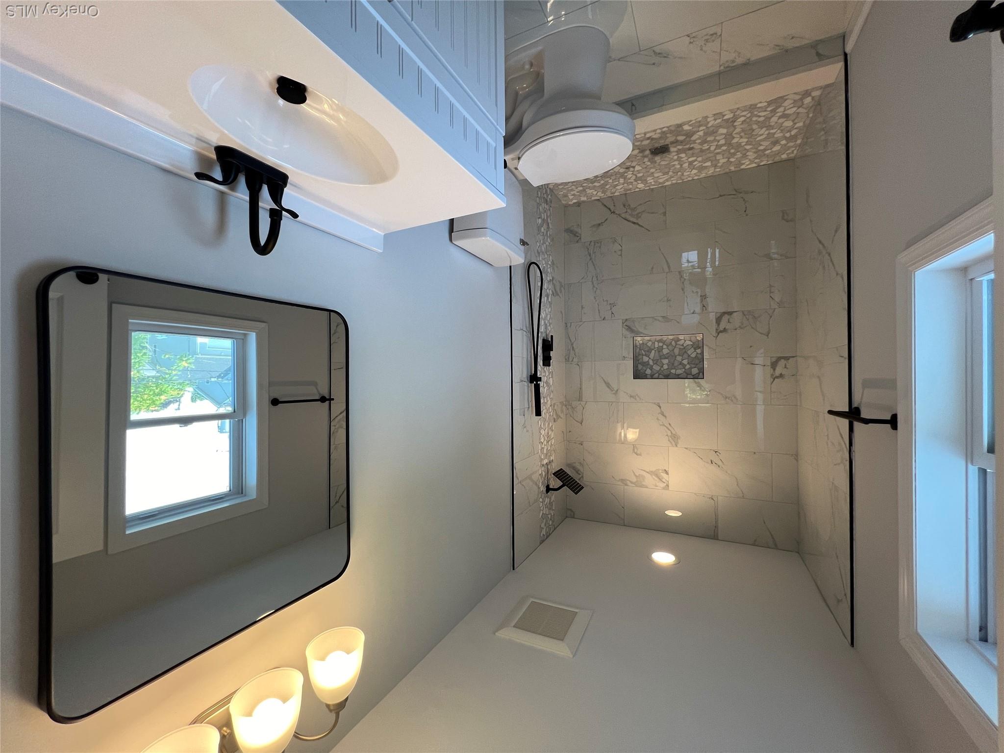 35 Babylon Road Mastic Beach, NY 11951 - Photo 19 of 19 a bathroom with a sink a toilet and shower