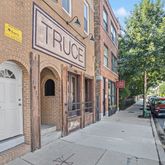a view of a building with car parked