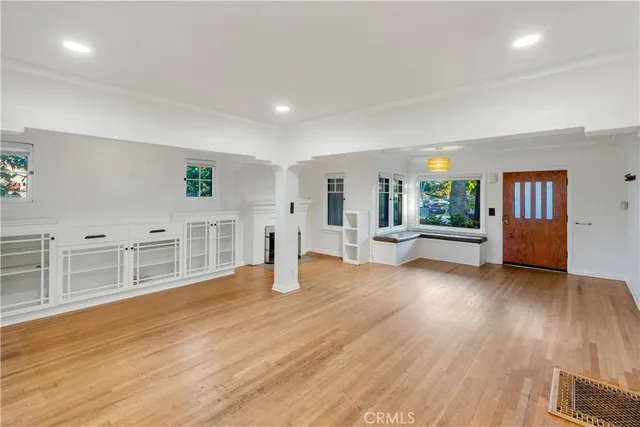 a living room with fireplace and wooden floor