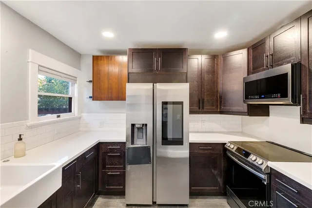 a kitchen with a refrigerator and a sink