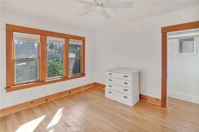 a view of a bedroom with furniture and a window