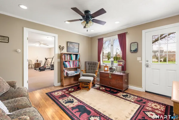 a living room with furniture and a ceiling fan