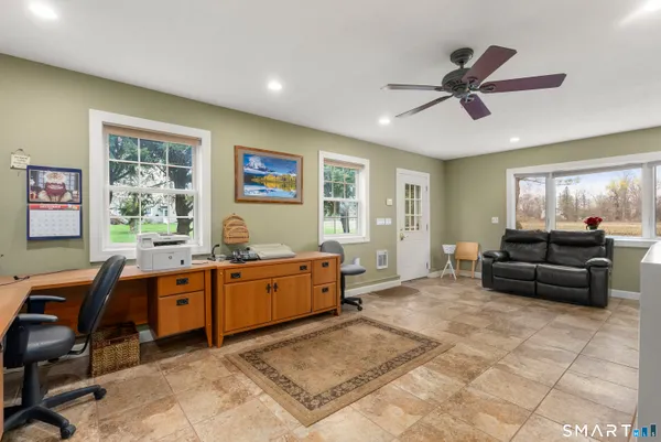 a view of a livingroom with furniture and a workspace