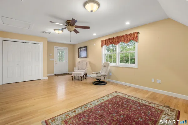 a living room with furniture a large window and a chandelier