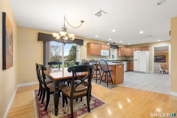 a kitchen with stainless steel appliances kitchen island granite countertop a refrigerator and a stove top oven