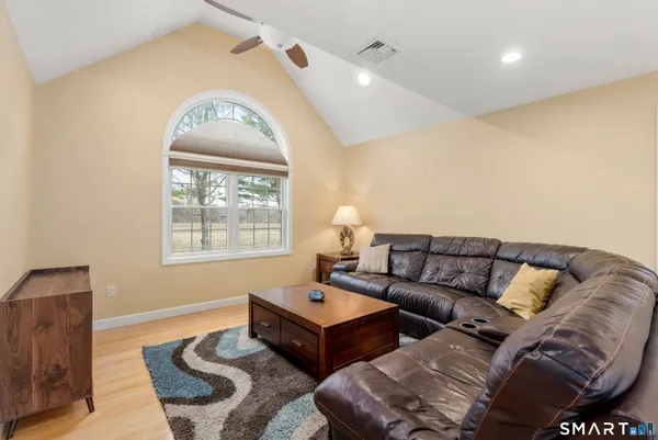 a living room with a couch and a lamp
