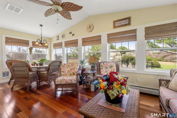a living room with furniture a large window and a fireplace