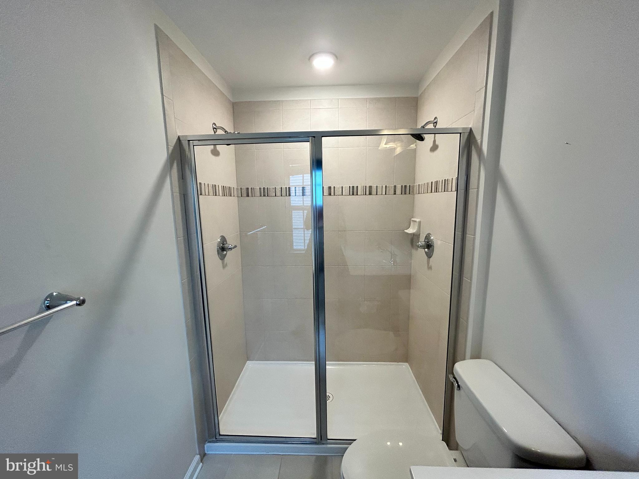 6170 Willow Place Bealeton, VA 22712 - Photo 19 of 28 a bathroom with a glass shower door