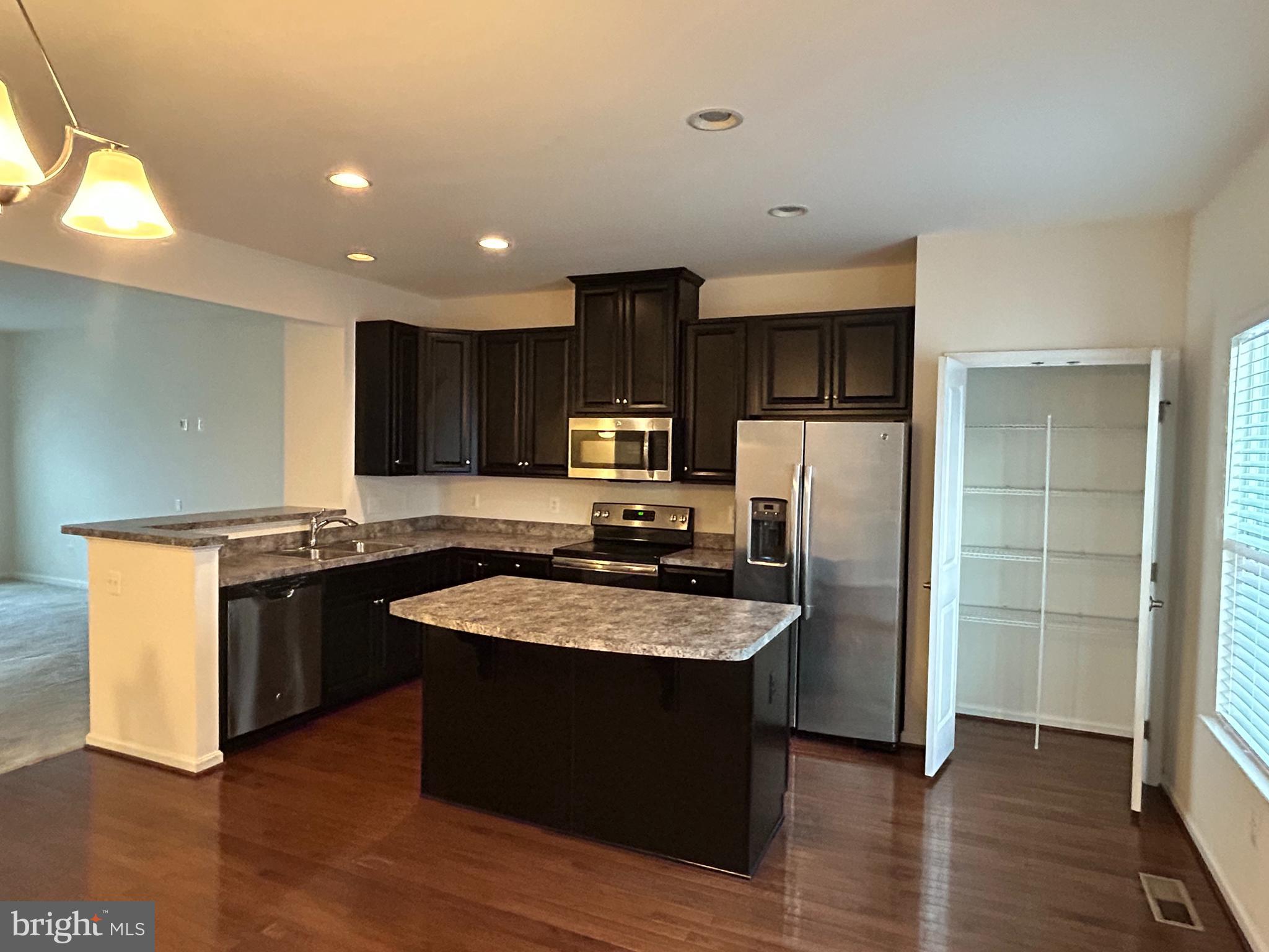 6170 Willow Place Bealeton, VA 22712 - Photo 7 of 28 a large kitchen with stainless steel appliances granite countertop a stove a sink dishwasher and a refrigerator
