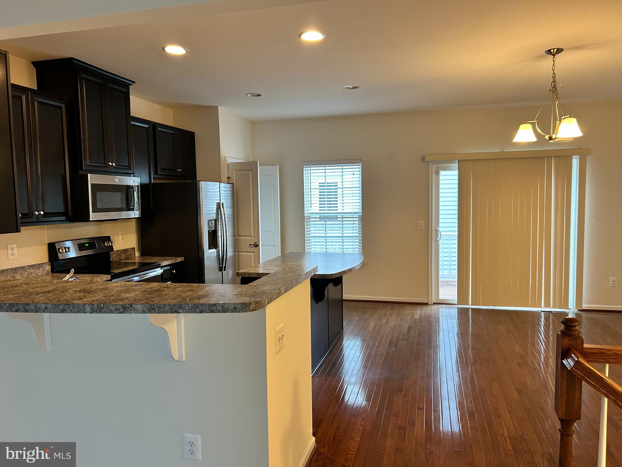 6170 Willow Place Bealeton, VA 22712 - Photo 9 of 28 a view of a kitchen island wooden floor and a window
