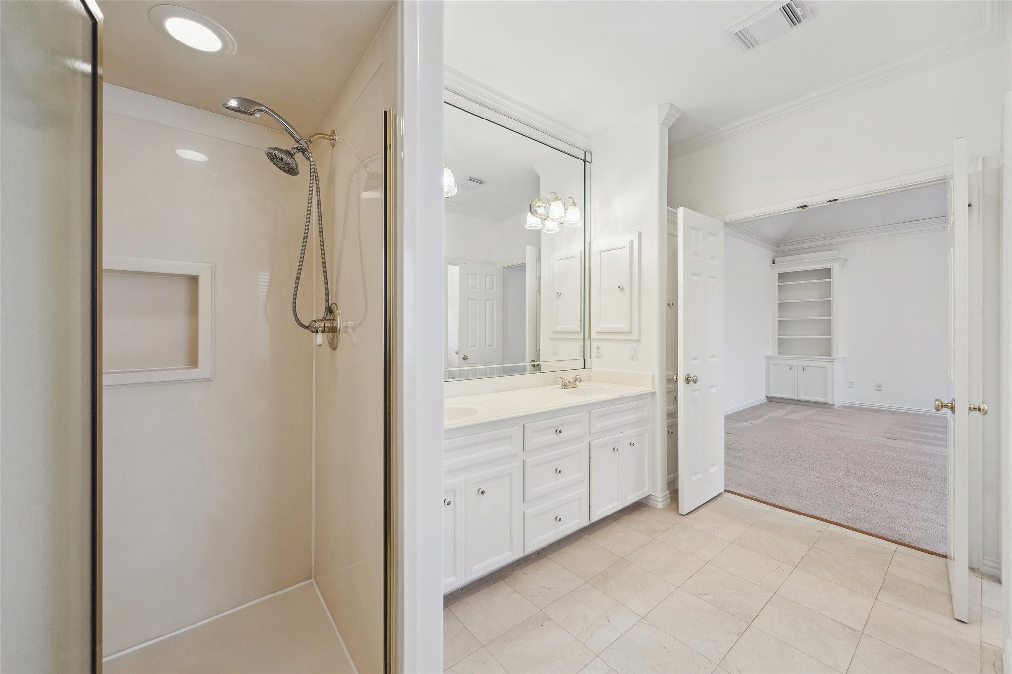 5107 Locust Street Bellaire, TX 77401 - Photo 29 of 45 Alternate view of the primary ensuite showcasing the seamless layout between the dual vanity and glass-enclosed shower, creating a bright, open feel with clean lines and thoughtful finishes throughout.