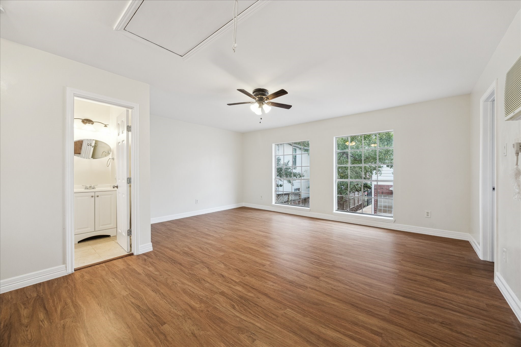 5107 Locust Street Bellaire, TX 77401 - Photo 36 of 45 The garage apartment features a spacious, open-concept living area with wood flooring, ceiling fan, and fantastic natural light from multiple windows.