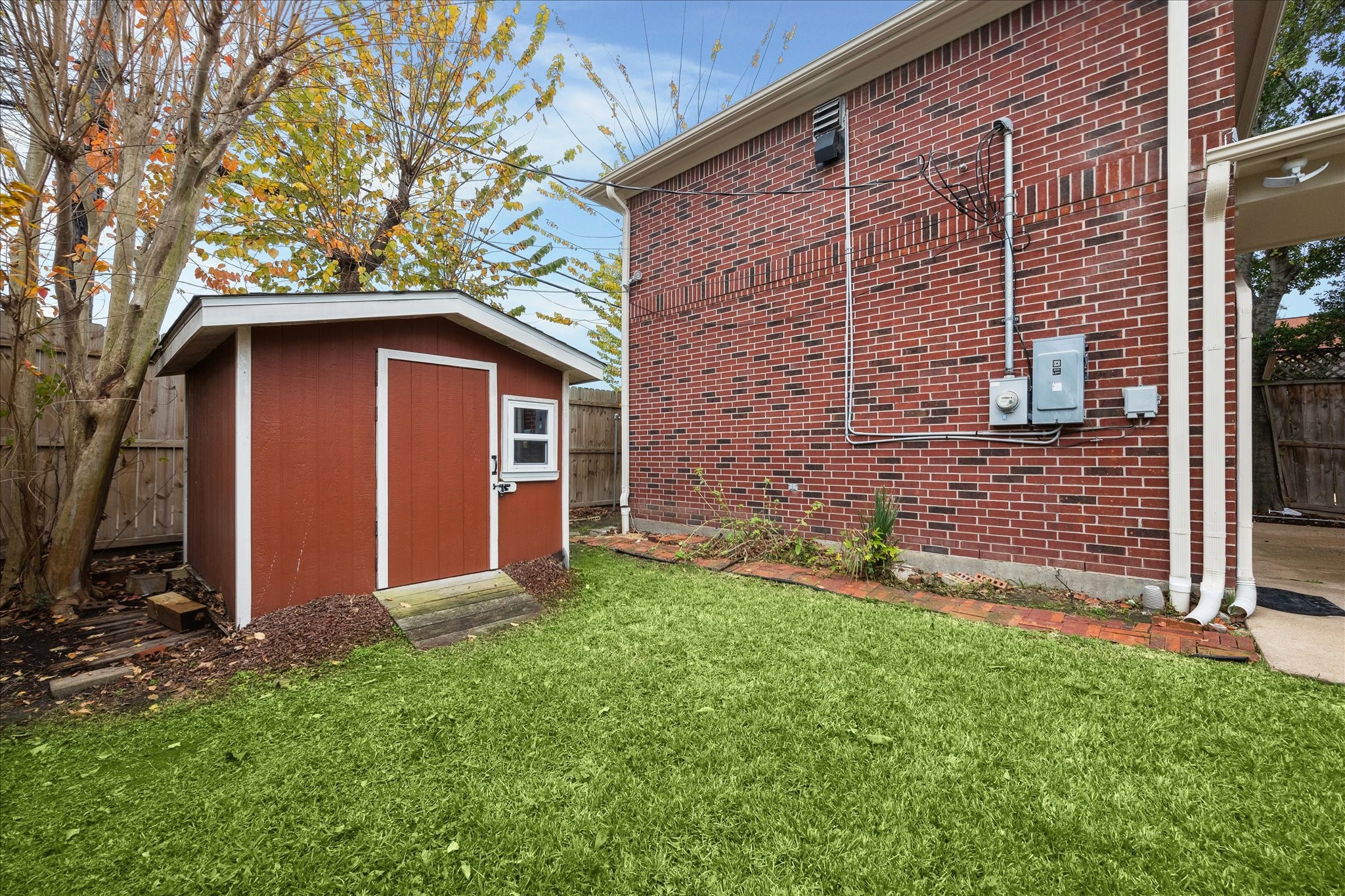 5107 Locust Street Bellaire, TX 77401 - Photo 42 of 45 Backyard includes a well-placed storage shed—ideal for lawn equipment, bikes, or extra storage.