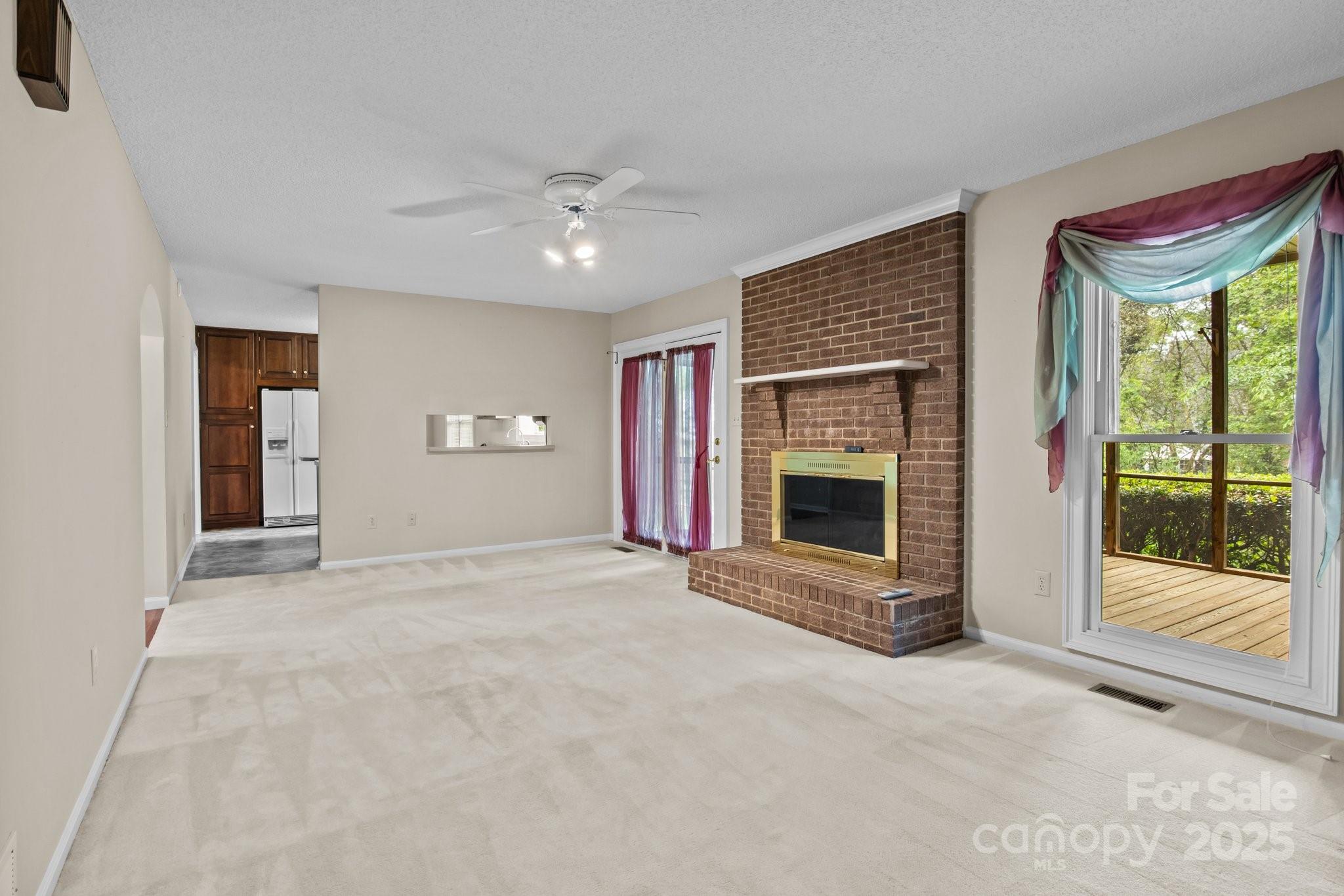 8368 Fairfield Forest Road Denver, NC 28037 - Photo 15 of 48 an empty room with windows and fireplace