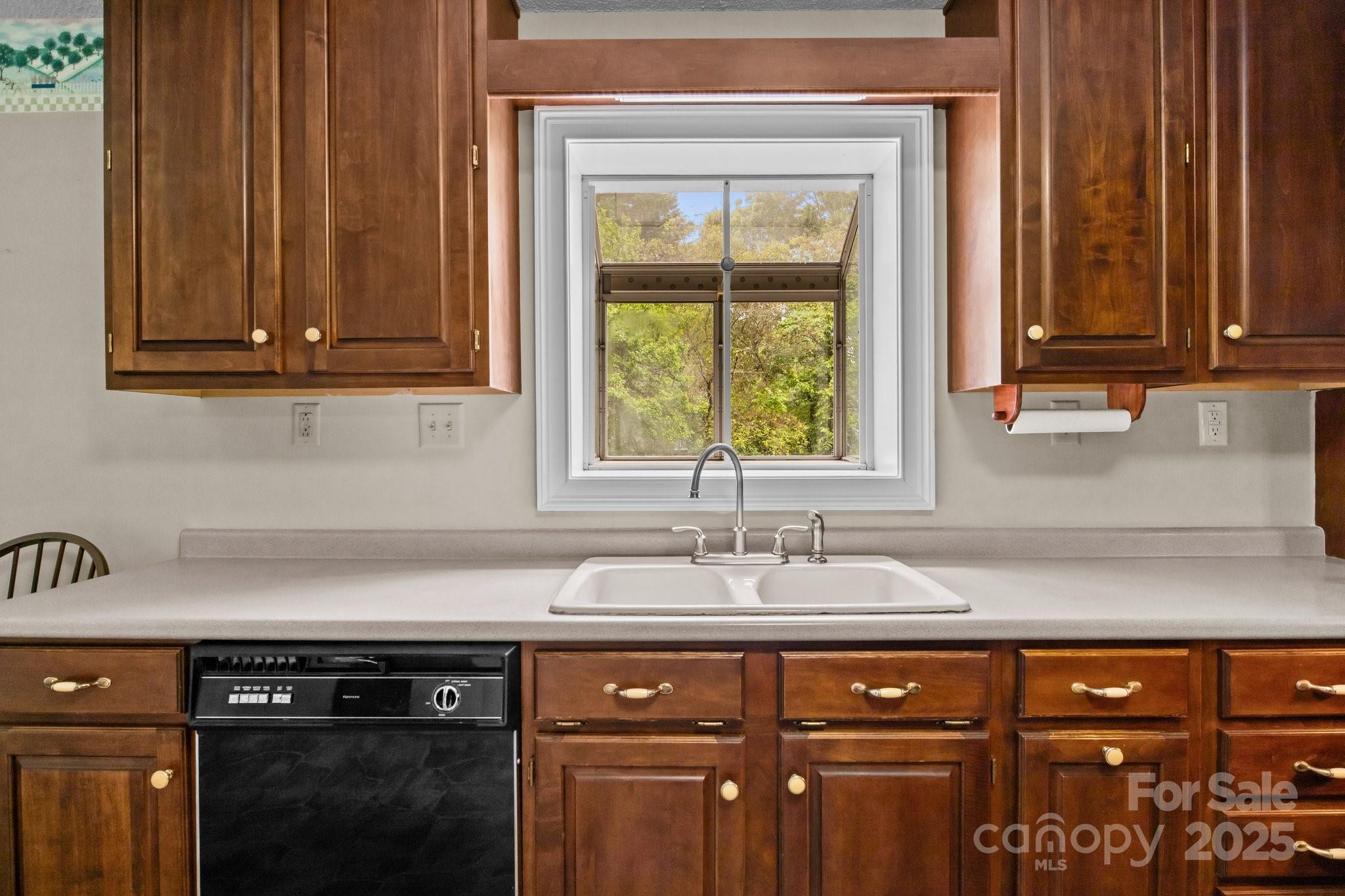 8368 Fairfield Forest Road Denver, NC 28037 - Photo 18 of 48 a kitchen with granite countertop cabinets sink and window