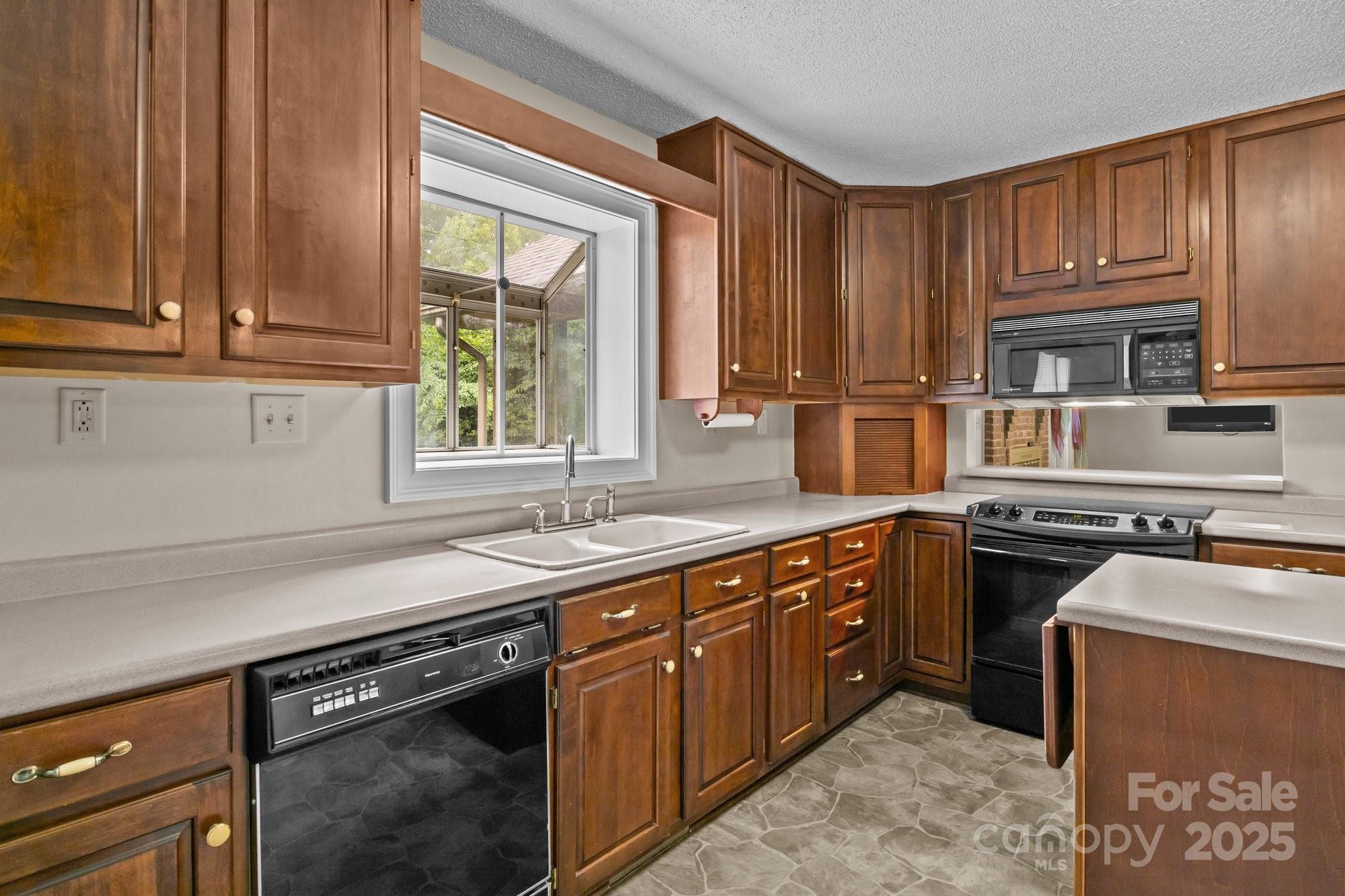 8368 Fairfield Forest Road Denver, NC 28037 - Photo 19 of 48 a kitchen with stainless steel appliances granite countertop a sink stove and cabinets