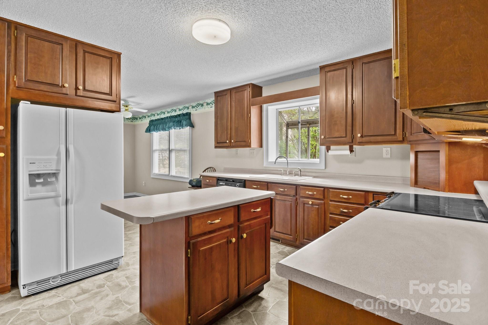8368 Fairfield Forest Road Denver, NC 28037 - Photo 21 of 48 a kitchen with stainless steel appliances granite countertop a sink stove and refrigerator
