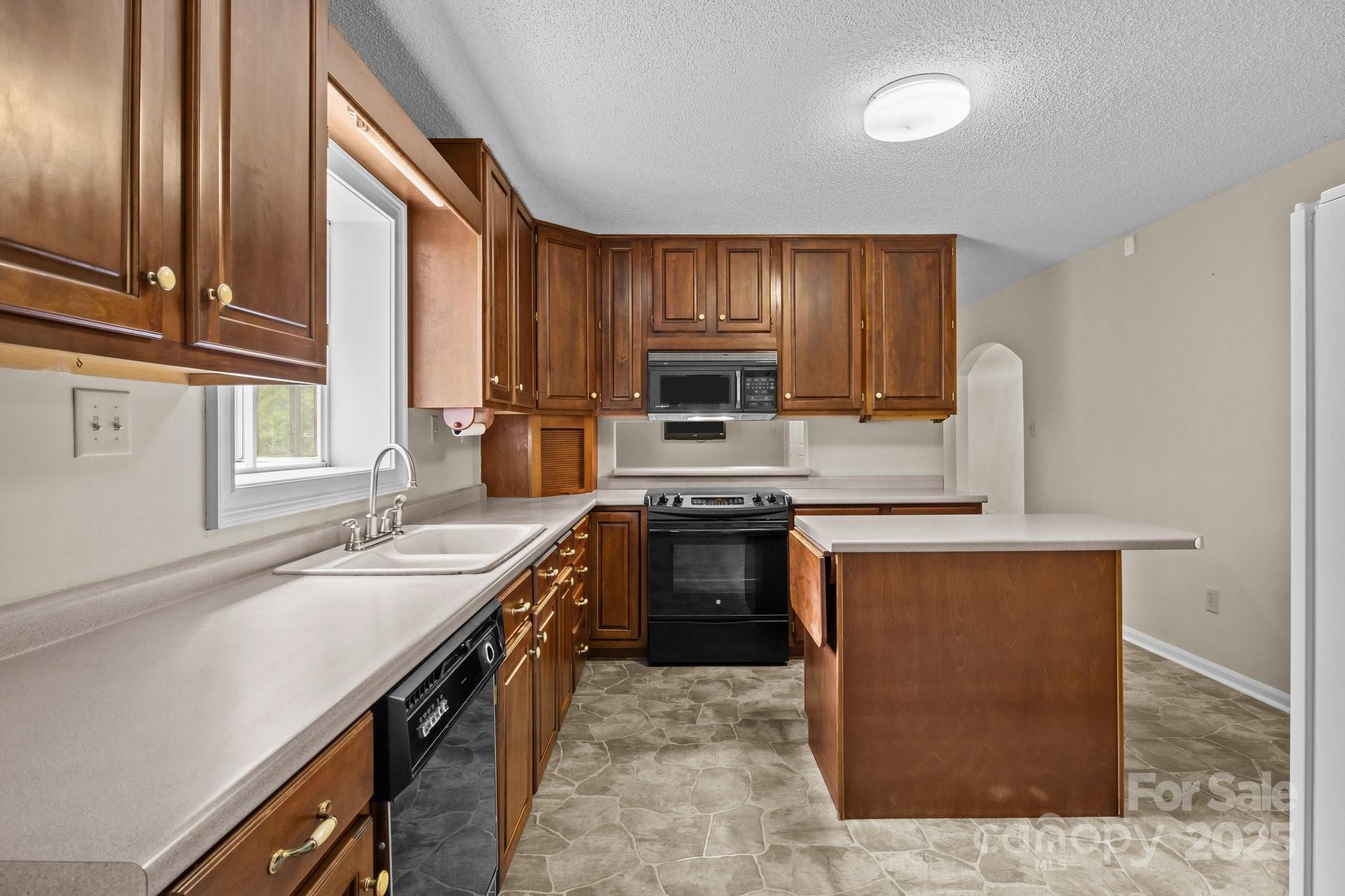 8368 Fairfield Forest Road Denver, NC 28037 - Photo 22 of 48 a kitchen with stainless steel appliances granite countertop a sink stove and refrigerator