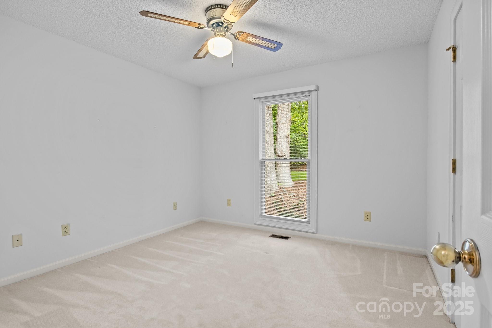 8368 Fairfield Forest Road Denver, NC 28037 - Photo 27 of 48 an empty room with windows and fan