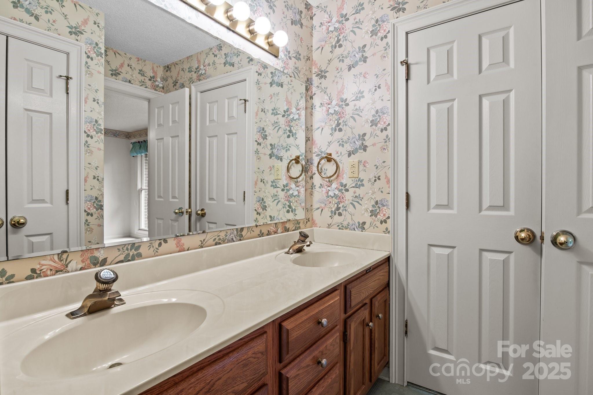 8368 Fairfield Forest Road Denver, NC 28037 - Photo 33 of 48 a bathroom with a sink and a mirror