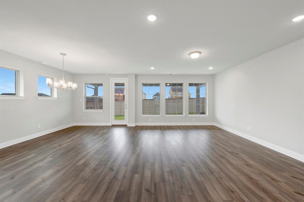 8916 Chestnut Lane Justin, TX 76247 - Photo 14 of 17 a view of an empty room with wooden floor and a window