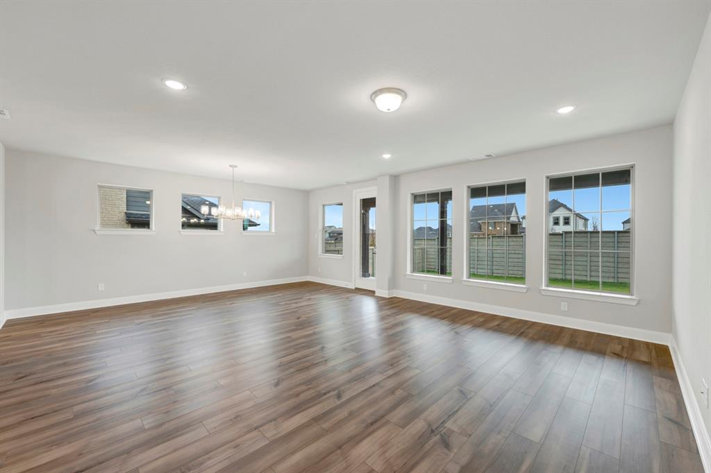 8916 Chestnut Lane Justin, TX 76247 - Photo 15 of 17 a view of an empty room with wooden floor and a window