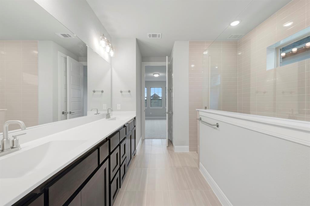 8916 Chestnut Lane Justin, TX 76247 - Photo 17 of 17 a bathroom with a sink a shower a mirror and a bathtub