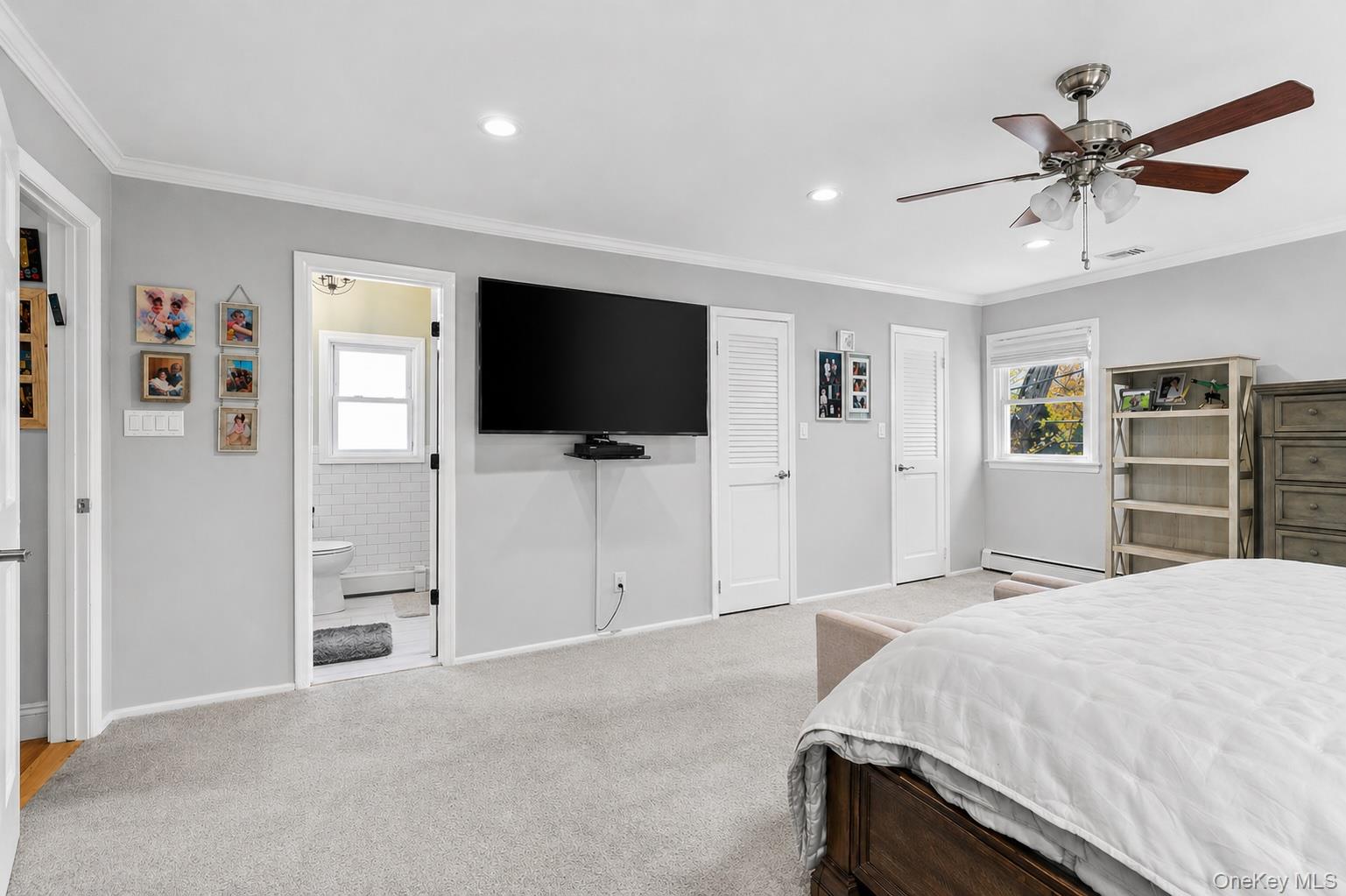 61 Winthrop Road Plainview, NY 11803 - Photo 18 of 37 a bedroom with a bed and a flat screen tv