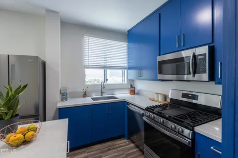 a kitchen with stainless steel appliances a stove a sink and a microwave