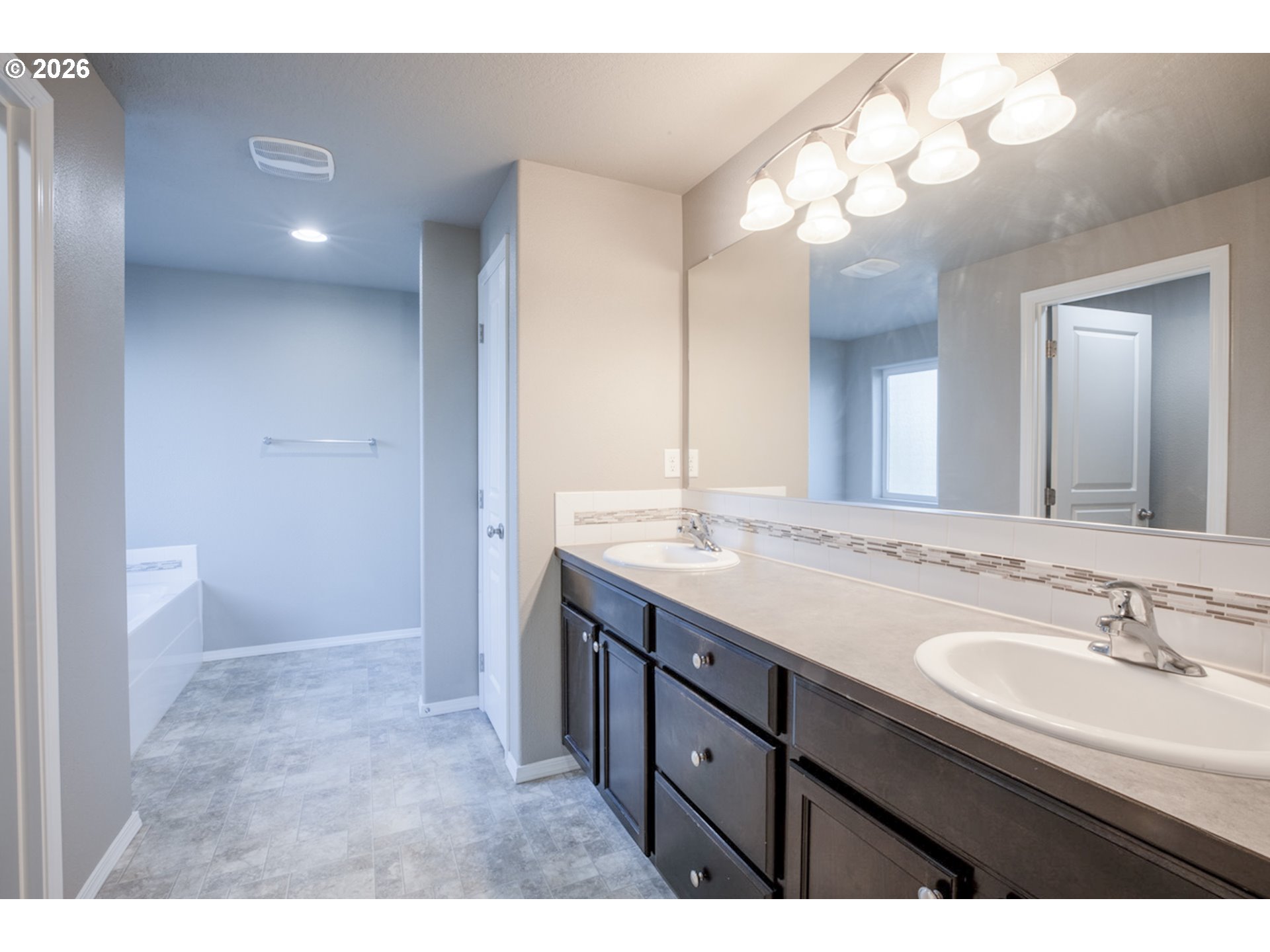 2952 Shelby Way Eugene, OR 97404 - Photo 15 of 25 a bathroom with a granite countertop sink a large mirror and a shower