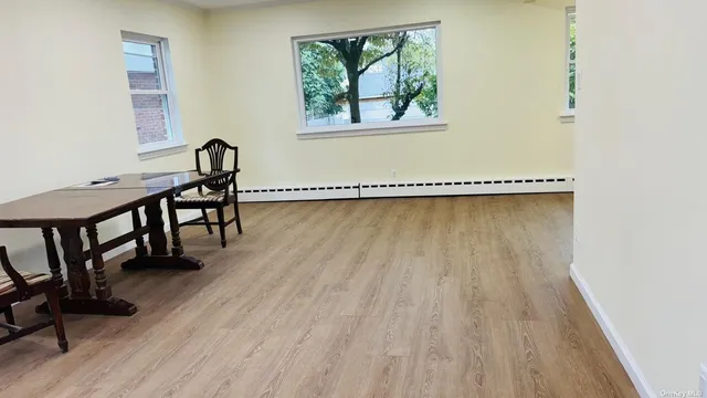 a view of a room with wooden floor and a window