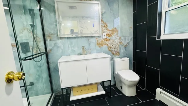 a bathroom with a toilet and a mirror