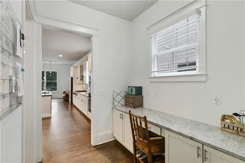 a utility room with wooden floor washer and dryer