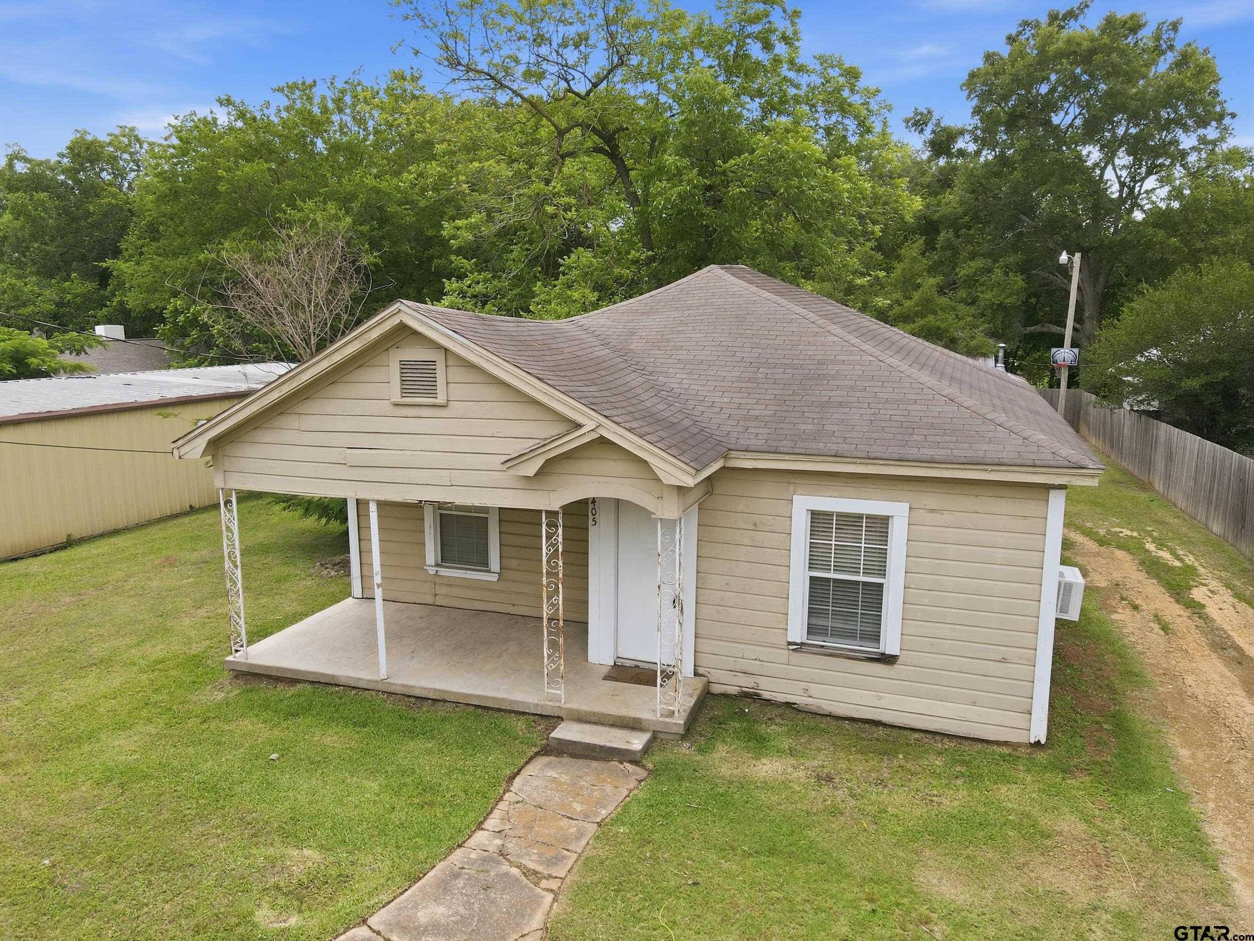 405 Rusk Street Pittsburg, TX 75686 - Photo 24 of 33 a view of a house with a yard