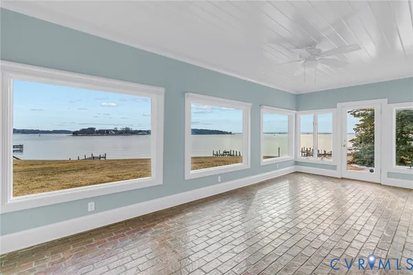a living room with furniture and floor to ceiling windows
