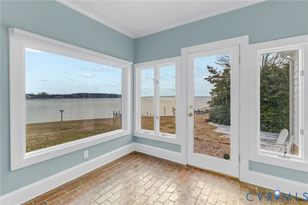 a view of a room with wooden floor and chandelier